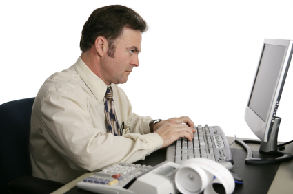 An accountant using an online program to do income taxes. An accountant using an online program to do income taxes.