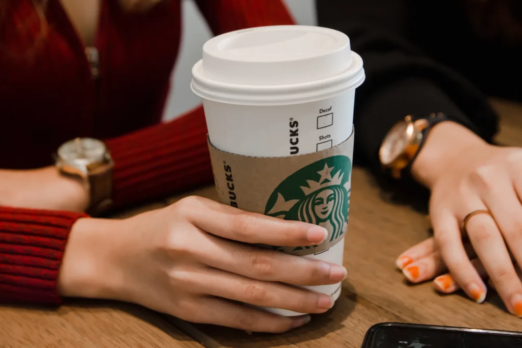 woman holding Starbucks coffee