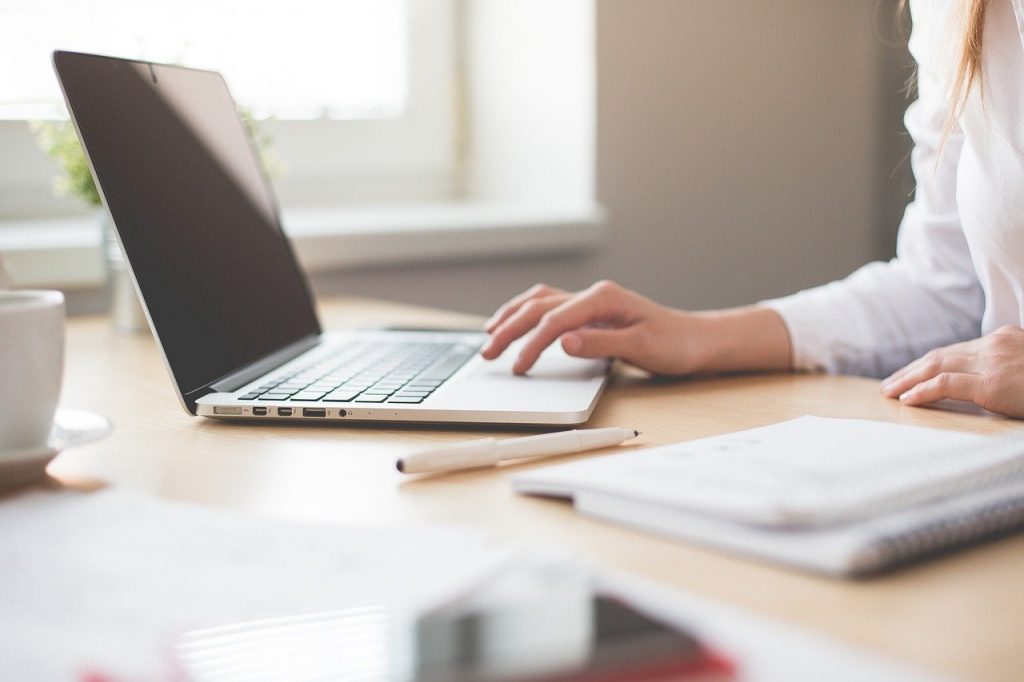 woman on her laptop and other work tech