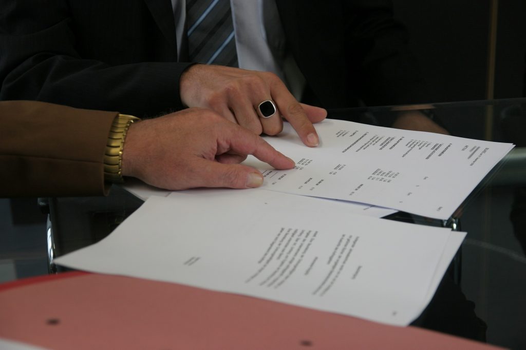 Person signing a contract for moving
