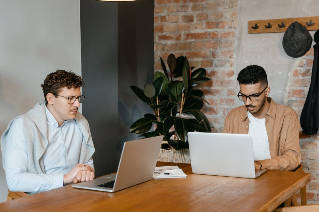 two people working on laptops