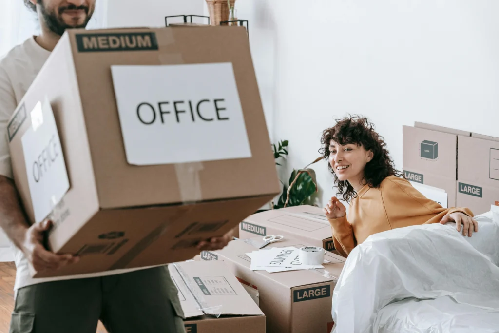 Moving offices: People surrounded by packed boxes
