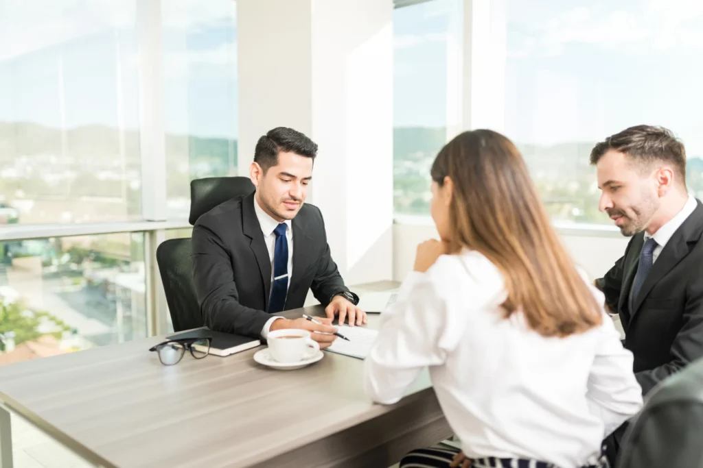 entrepreneurs signing a business loan without personal guarantee