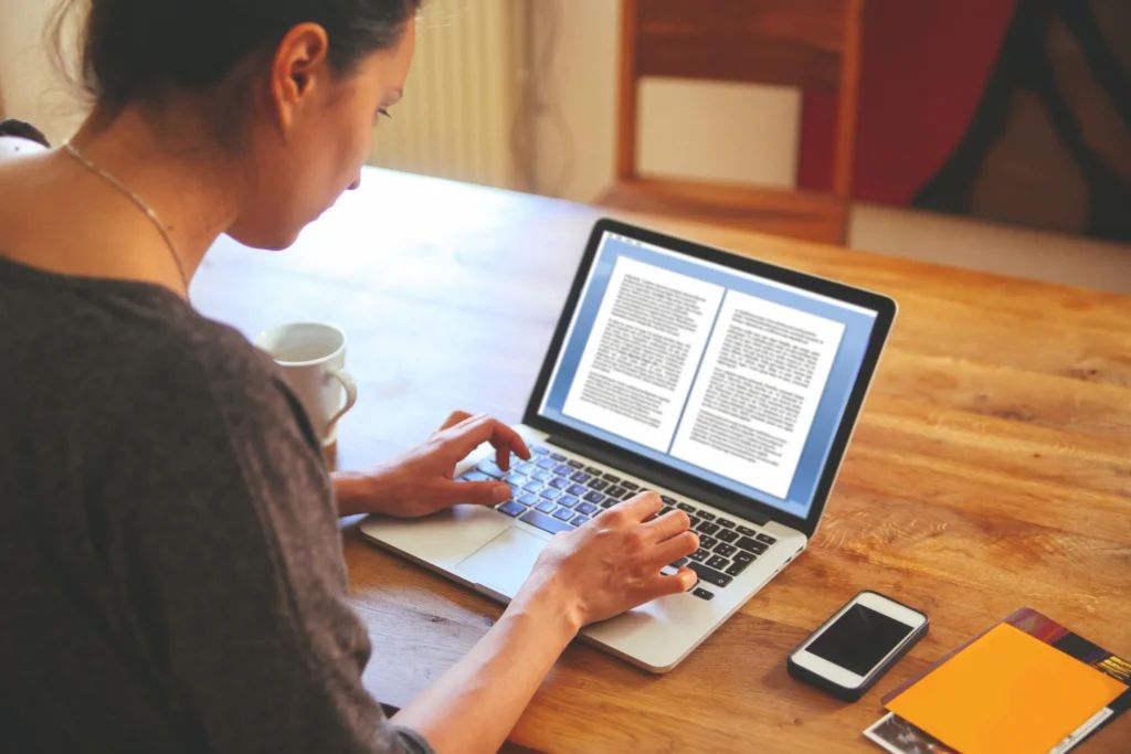 earn money from writing : woman typing on computer