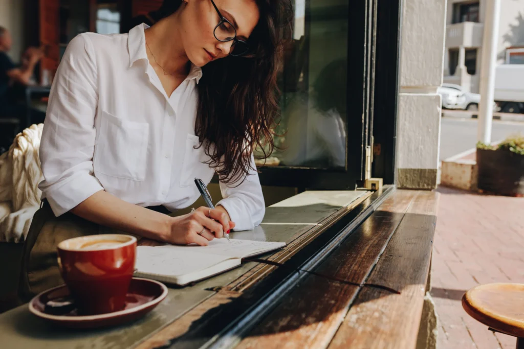 earn money from writing : woman writing on notebook