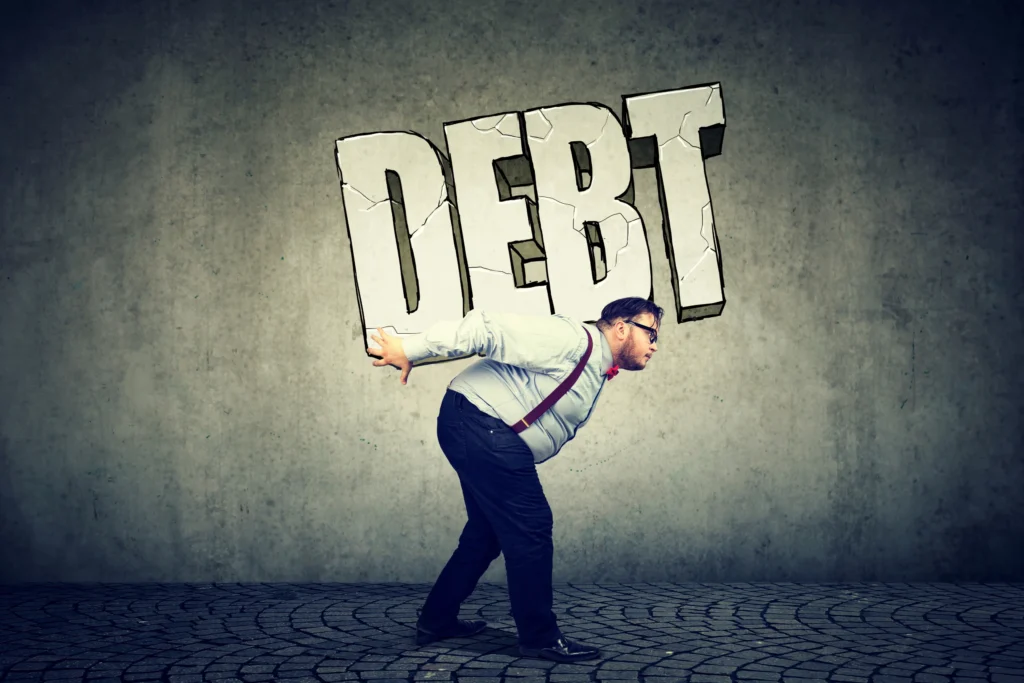 building wealth: man weighed down by debt