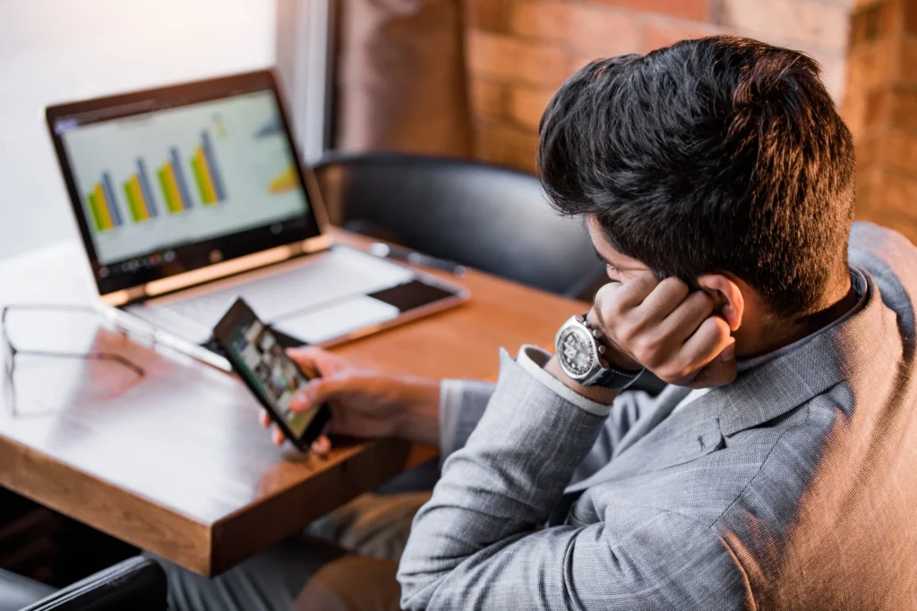 procrastination: man playing on phone instead of working